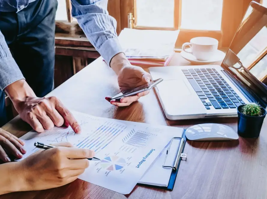 Two coworkers reviewing tax data.