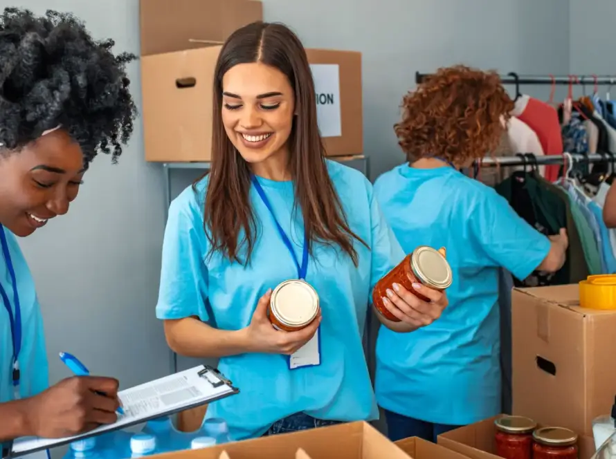 Volunteers working for a nonprofit organization, boxing food ,sorting clothes, etc.