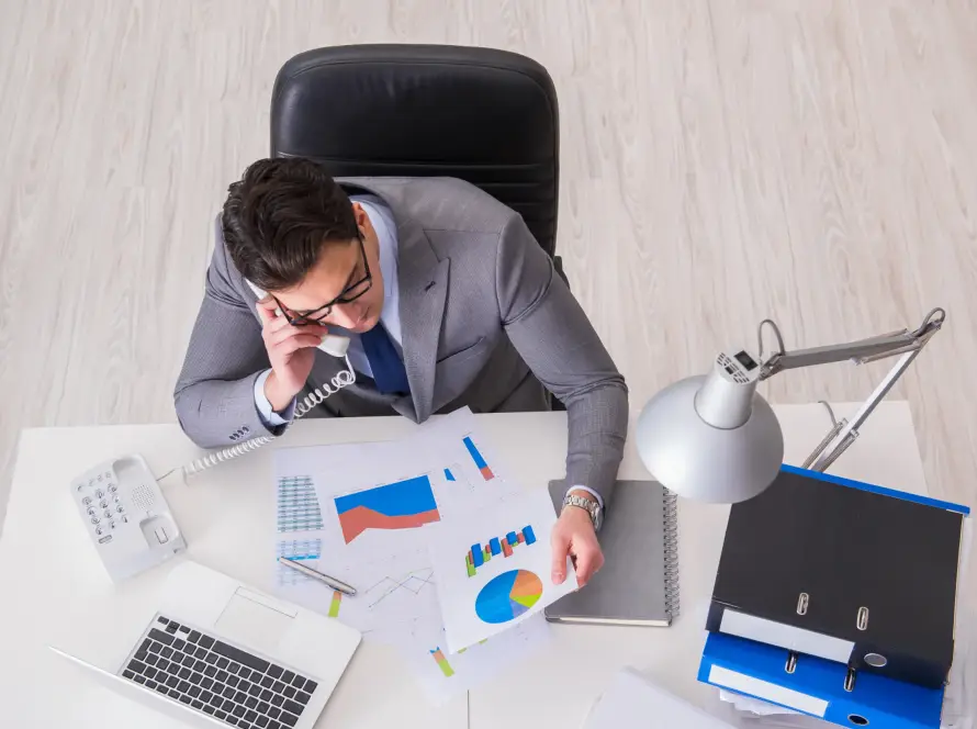 A CFO reviewing analytics while talking on the phone.
